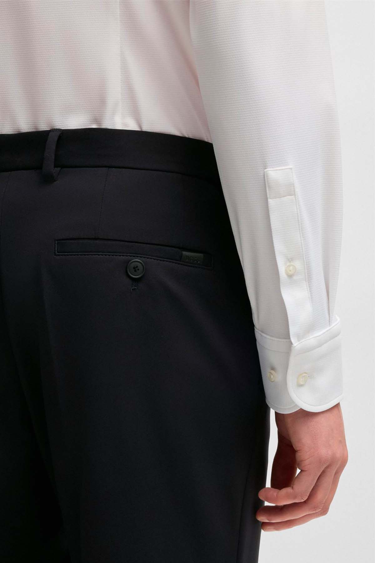 Pantalones slim fit de punto elástico técnico image number 2